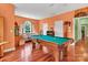 Well-lit game room boasts a pool table, hardwood floors, and multiple windows for a bright, inviting space at 103 Samuel Guilford Ct, Charlotte, NC 28270