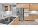 Modern kitchen featuring stainless steel appliances, a cooktop island, and plenty of cabinet space at 103 Samuel Guilford Ct, Charlotte, NC 28270