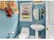 Stylish powder room with a pedestal sink, decorative mirror, and unique wall decor at 103 Samuel Guilford Ct, Charlotte, NC 28270