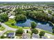 Scenic aerial view of a community featuring a pond with a fountain and lush green spaces at 114 Nevis Ln, Mooresville, NC 28115
