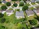 Aerial view of a home with a fenced backyard and mature trees in a residential neighborhood at 114 Nevis Ln, Mooresville, NC 28115