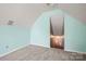 Unfinished attic area with gray carpet and access to storage at 114 Nevis Ln, Mooresville, NC 28115