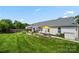 This backyard features a patio area, picnic table and spacious lawn at 114 Nevis Ln, Mooresville, NC 28115