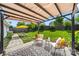 Enjoy outdoor living on this backyard patio with pergola, furniture, and manicured lawn at 114 Nevis Ln, Mooresville, NC 28115