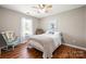 Cozy bedroom with hardwood floors, a comfortable bed, and a calming rocking chair at 114 Nevis Ln, Mooresville, NC 28115