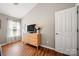 Well-lit bedroom featuring wood floors, a large window, and a built-in dresser, providing a comfortable and functional living space at 114 Nevis Ln, Mooresville, NC 28115