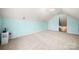 Expansive bonus room with neutral carpeting, angled ceilings, and multiple electrical outlets at 114 Nevis Ln, Mooresville, NC 28115