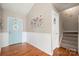 Inviting entryway featuring a blue front door, wood-look flooring, and staircase leading to the second floor at 114 Nevis Ln, Mooresville, NC 28115