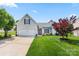 Beautiful home with a two-car garage, well-kept lawn, and mature landscaping in a suburban neighborhood at 114 Nevis Ln, Mooresville, NC 28115