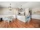 Open kitchen and breakfast area with a large island, pendant lighting, wood flooring, and eat in dining at 114 Nevis Ln, Mooresville, NC 28115