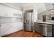 Updated kitchen with stainless steel appliances, modern subway tile backsplash, lots of cabinet space, and wood flooring at 114 Nevis Ln, Mooresville, NC 28115