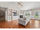 Cozy living room featuring built-in shelving, a fireplace, wood floors, and a comfortable gray sofa at 114 Nevis Ln, Mooresville, NC 28115