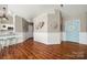Open-concept living space with stylish decor, wood floors, and a glimpse into the modern kitchen at 114 Nevis Ln, Mooresville, NC 28115