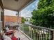 Relaxing balcony with metal railing, a small table, and comfortable seating with red cushions at 11530 Costigan Ln, Charlotte, NC 28277
