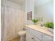 Bright bathroom features a white vanity, framed mirror, and tub-shower with decorative curtain at 11530 Costigan Ln, Charlotte, NC 28277