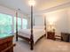 Spacious bedroom with a four-poster bed and plenty of natural light at 11530 Costigan Ln, Charlotte, NC 28277
