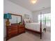 Bedroom with a four-poster bed, dresser, and ample natural light from the window at 11530 Costigan Ln, Charlotte, NC 28277