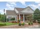 Charming building featuring a brick facade, large windows, and well-manicured landscaping at 11530 Costigan Ln, Charlotte, NC 28277