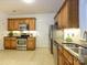 Spacious kitchen featuring wood cabinets, stainless steel appliances, granite countertops and tile flooring at 11530 Costigan Ln, Charlotte, NC 28277