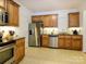 Bright and cheery kitchen with granite countertops, stainless steel appliances and wooden cabinets at 11530 Costigan Ln, Charlotte, NC 28277