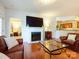 Cozy living room featuring fireplace, hardwood floors, and an open layout at 11530 Costigan Ln, Charlotte, NC 28277