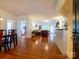 Open concept living room with hardwood floors and a fireplace plus a dining room just off the entry at 11530 Costigan Ln, Charlotte, NC 28277