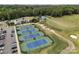 Aerial view of tennis courts and community pool in a lush, green neighborhood with mature trees at 11909 Cupworth Ct, Huntersville, NC 28078