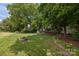 Landscaped backyard featuring an outdoor fire pit at 11909 Cupworth Ct, Huntersville, NC 28078