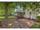 Backyard patio with a screened porch overlooking the lawn at 11909 Cupworth Ct, Huntersville, NC 28078