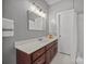 Bathroom vanity with a white countertop, dark wood cabinets, and gold fixtures at 11909 Cupworth Ct, Huntersville, NC 28078