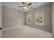 Neutral bedroom featuring two windows and a ceiling fan at 11909 Cupworth Ct, Huntersville, NC 28078