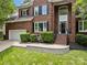 Charming brick facade with a two-car garage, complemented by lush landscaping and a welcoming entrance at 11909 Cupworth Ct, Huntersville, NC 28078