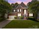 Beautiful two-story brick home with a well-manicured lawn, mature trees, and an attached two-car garage at 11909 Cupworth Ct, Huntersville, NC 28078