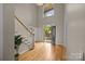 Bright foyer with hardwood floors, a staircase, and a large window, showcasing a grand entry at 11909 Cupworth Ct, Huntersville, NC 28078