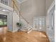 Spacious foyer with hardwood floors, a staircase, and glass paneled doors, allowing for natural light at 11909 Cupworth Ct, Huntersville, NC 28078