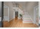 Inviting foyer with hardwood floors, a staircase, and neutral paint, creating a warm and welcoming atmosphere at 11909 Cupworth Ct, Huntersville, NC 28078