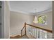 Bright foyer with an elegant chandelier, staircase with wood railing, and a view of the front door at 11909 Cupworth Ct, Huntersville, NC 28078