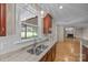 Kitchen sink and granite countertops with dark wood cabinets and a view to the backyard at 11909 Cupworth Ct, Huntersville, NC 28078