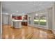 Open kitchen and eating area featuring dark wood cabinetry, granite counters, and views of the back yard at 11909 Cupworth Ct, Huntersville, NC 28078