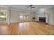 Bright living room with hardwood floors, fireplace, and large windows overlooking the yard at 11909 Cupworth Ct, Huntersville, NC 28078