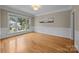 Open living room featuring hardwood floors, wainscoting, and ample natural light, perfect for entertaining at 11909 Cupworth Ct, Huntersville, NC 28078