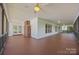 Expansive covered porch with brick fireplace and ceiling fans at 11909 Cupworth Ct, Huntersville, NC 28078