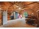 Unfinished attic featuring exposed beams, a window, and ample storage space at 12900 Westmoreland Rd, Huntersville, NC 28078