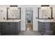 Bathroom with double vanity and view to bedroom through a doorway at 12900 Westmoreland Rd, Huntersville, NC 28078