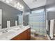 Bathroom features a double sink vanity and a shower with a patterned curtain at 12900 Westmoreland Rd, Huntersville, NC 28078
