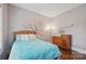 Comfortable bedroom with hardwood floors and a wooden dresser at 12900 Westmoreland Rd, Huntersville, NC 28078