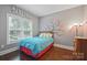 Comfortable bedroom with gray walls, hardwood floors, and a window overlooking the pool at 12900 Westmoreland Rd, Huntersville, NC 28078