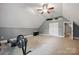 Spacious carpeted bonus room with ceiling fan, storage, and an office area at 12900 Westmoreland Rd, Huntersville, NC 28078