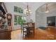 Dining room with hardwood floors, a chandelier, and views of the front entryway at 12900 Westmoreland Rd, Huntersville, NC 28078