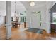 A bright foyer with hardwood floors and views into the dining room at 12900 Westmoreland Rd, Huntersville, NC 28078